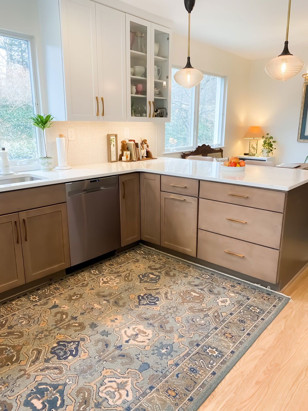 Pure kitchen remodel with contemporary colors, pale birch wood floors, and a pastel area rug