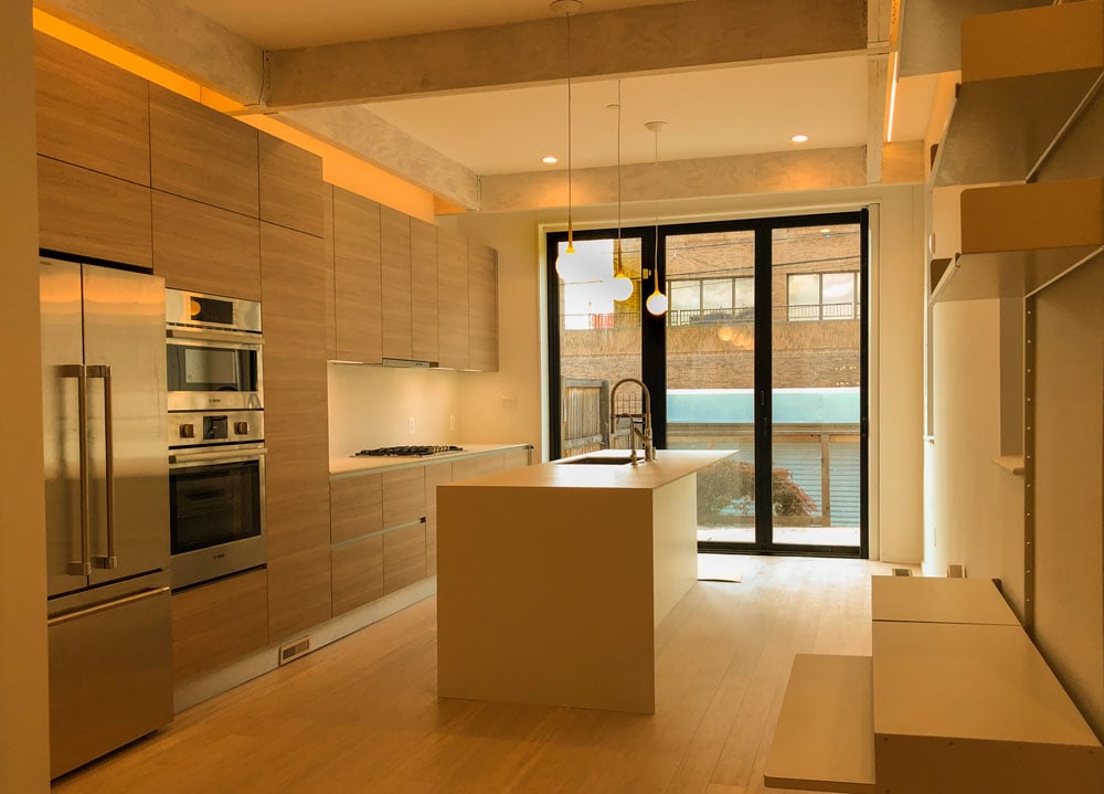 Wooden kitchenette with warm yellow lighting
