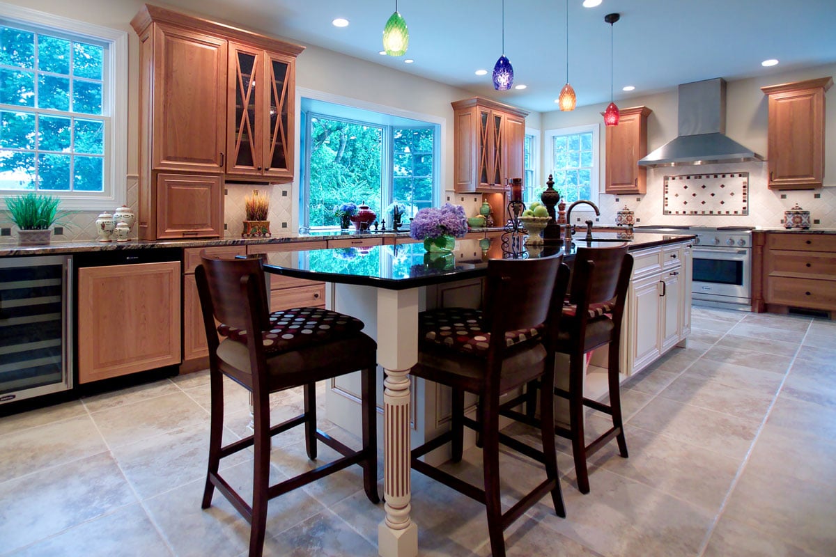 Kitchen island and dining room combo with dark wood high-boy chairs
