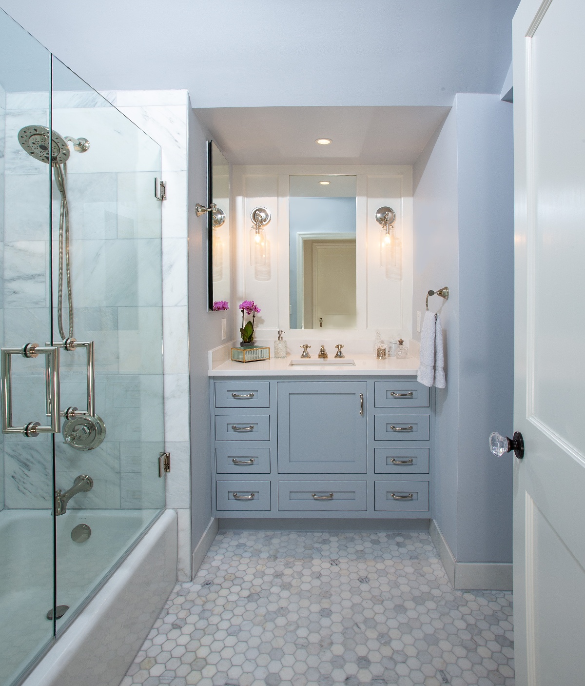 White bathroom with luxurious walk-in shower and a cubby with a single bathroom vanity