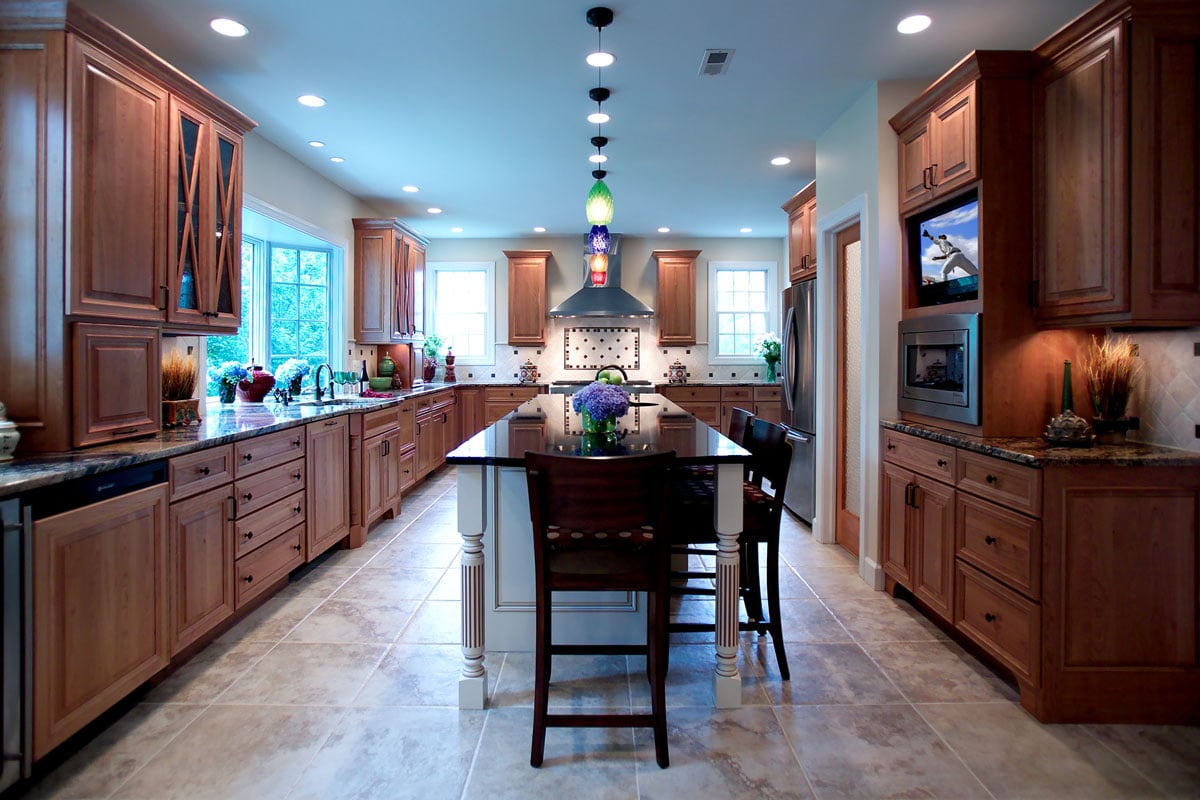 Seating for three around a kitchen island in the middle of a transitional kitchen design